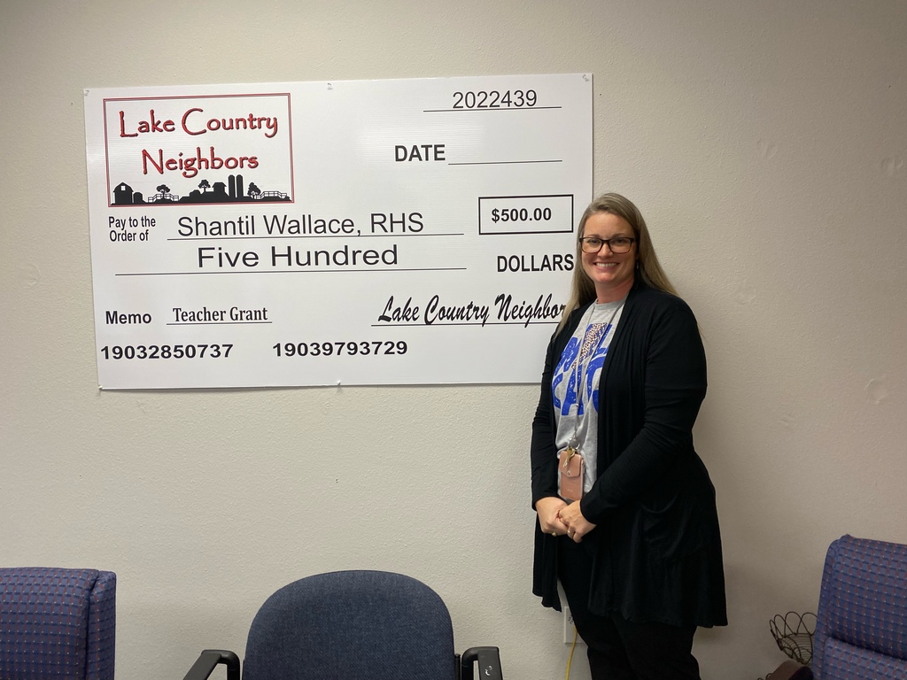S. Wallace posing with her giant $500 check from Lake Country Neighbors