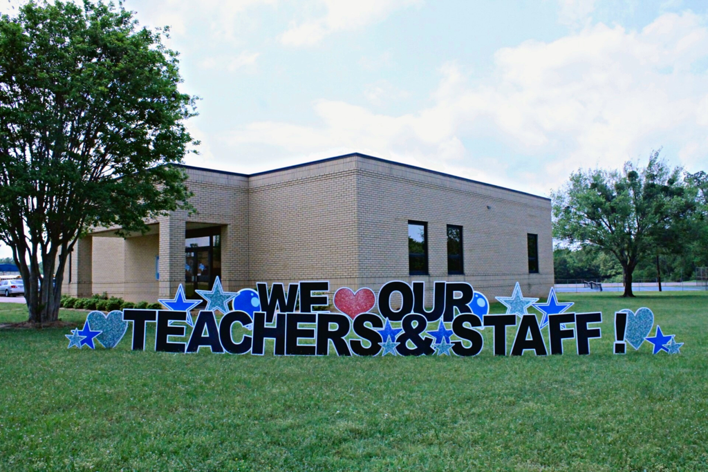 We (heart) our teachers & staff yard sign in front of the Rains ISD Administration building
