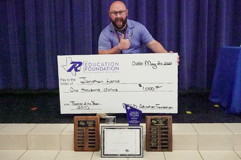 District Teacher of the Year 2023 - Jonathan Lance poses with his awards